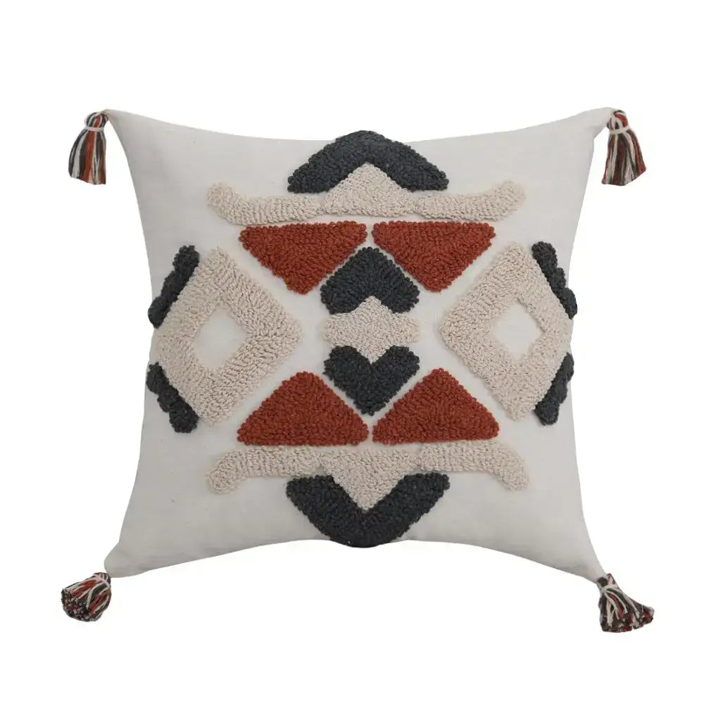 Cream-colored boho style embroidered pillow cover with rust geometric pattern and multicolored tassels for decorbites decor