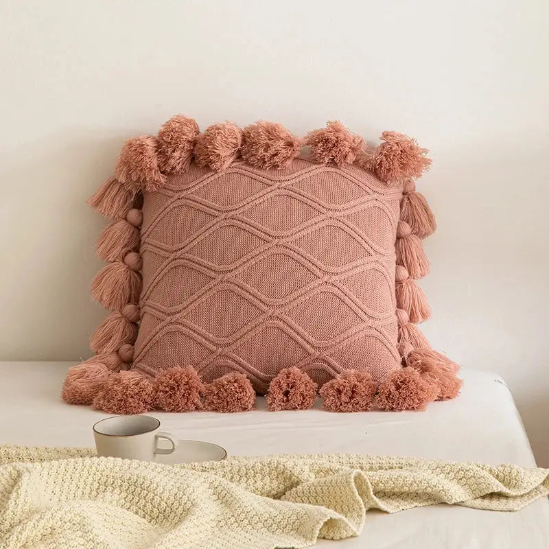 A cozy blush pink knitted cushion cover with diamond pattern and tassels for decorbites boho style ivory decor
