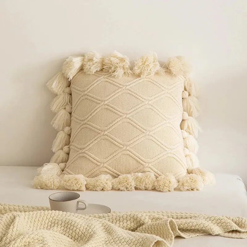 Cream-colored knitted throw pillow with diamond pattern and tassels for decorbites boho style ivory cushion cover