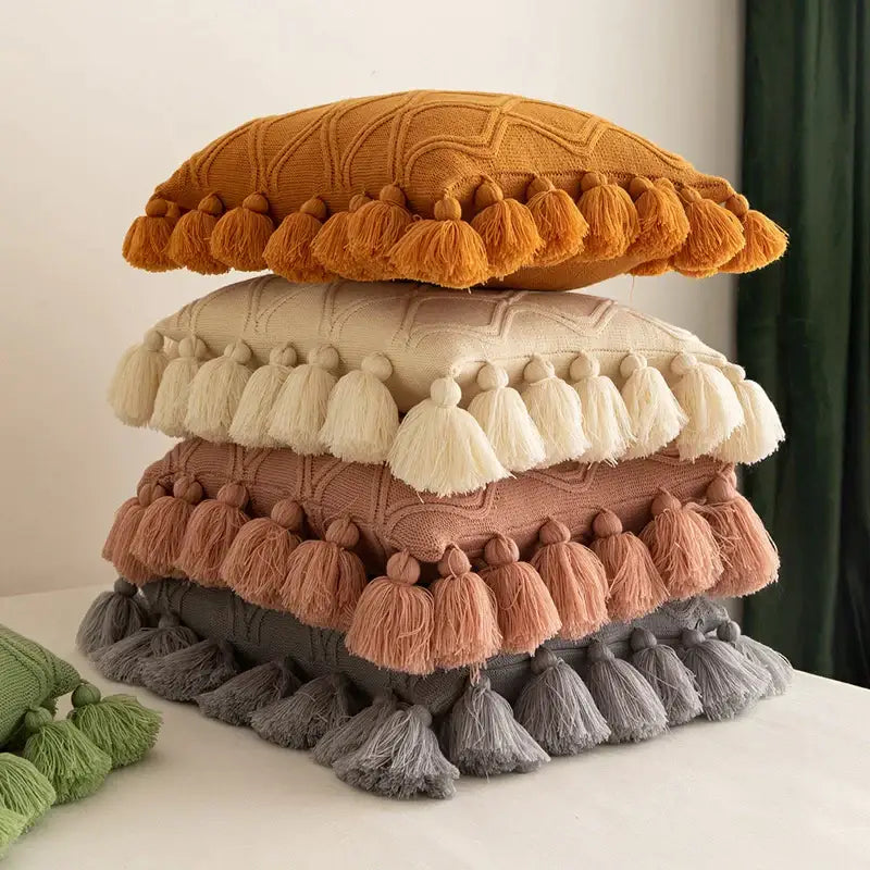 Stack of four textured boho style ivory and pastel cushion covers with matching tassel fringe for living room decorbites decor