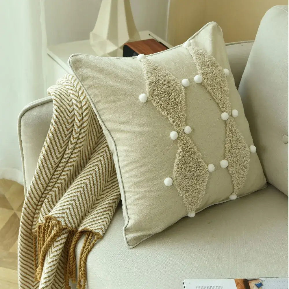 Beige cushion cover with textured fluffy appliqué panels and white pom poms boho style ivory decorbites decor