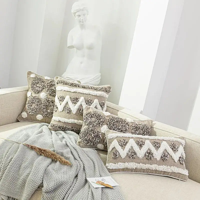 Beige textured throw pillows with white and gray fringe detail in decorbites boho style tufted cushion cover for living room