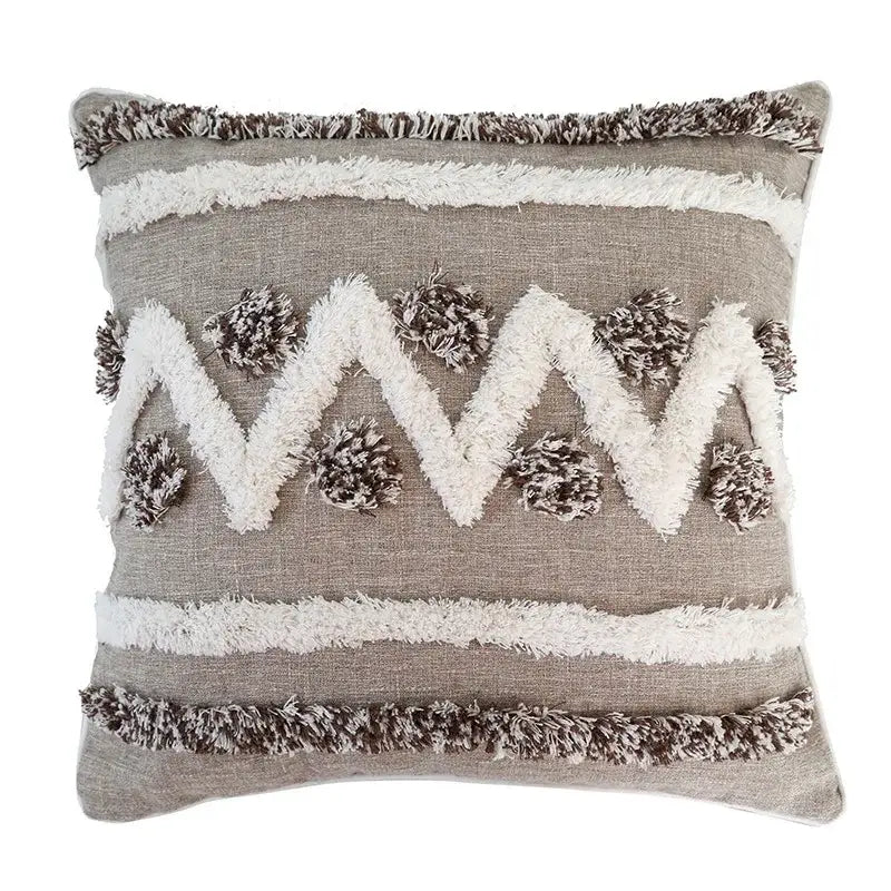 Gray and white woven zigzag cushion cover with fringe trim and pom-poms in decorbites boho style tufted design