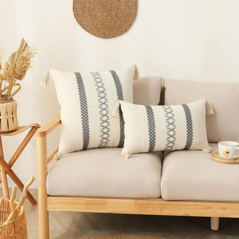 Cream-colored boho tassel cushion cover with gray geometric stripes and woven textile for decorbites boho tassel decor