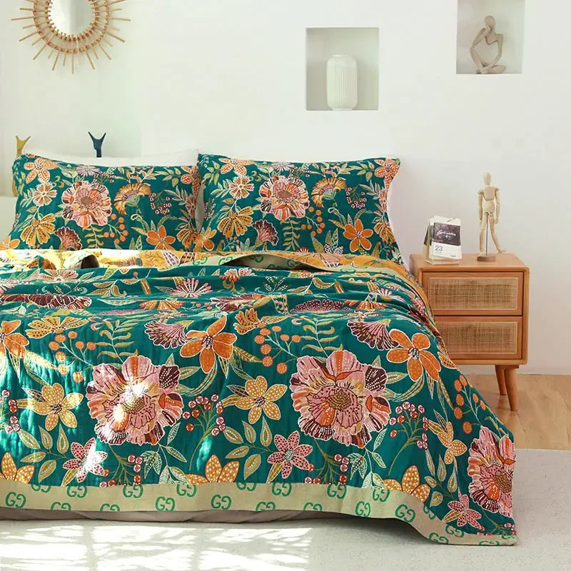 Boho teal floral cotton cover throw blanket with orange and pink blossoms and gucci logo trim along bottom edge