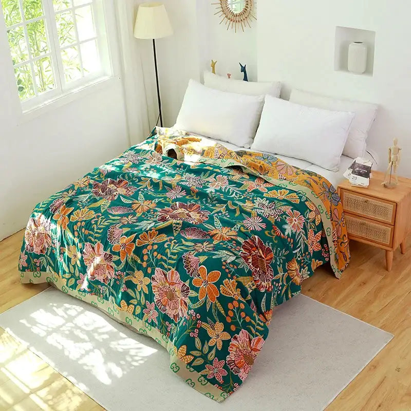 Vibrant teal floral cotton cover throw blanket with orange and pink blossoms and a soft textured weave