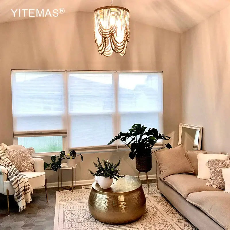 Gold hammered metal coffee table under a boho tiered wooden beaded chandelier for dining room lighting