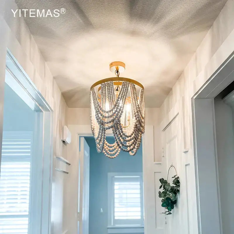 Gold-toned wooden beaded chandelier with cascading light wooden beads for dining room boho tiered lighting
