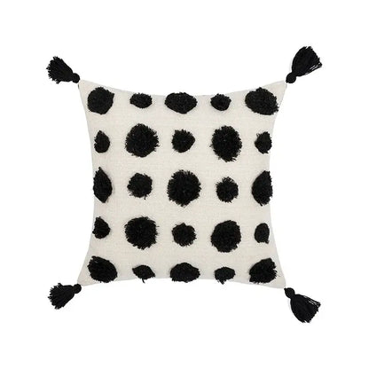 Off-white pillow cover with black textured pom-poms and tassels for decorbites boho tufted beige living room decor