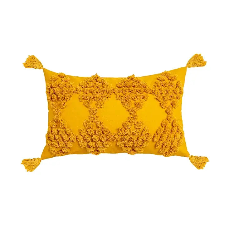 Vibrant mustard-yellow pillow cover with fluffy pom-poms and tassels from decorbites boho tufted beige collection