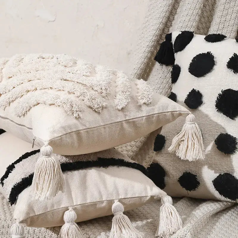 Cream-colored boho tufted beige pillow cover with textured fringed tassels and black and white polka dot decorbites design