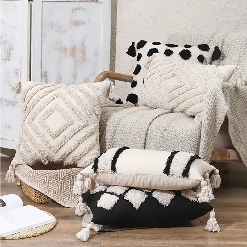 Cream-colored boho tufted beige pillow cover with black and white geometric patterns and tassels for living room decor