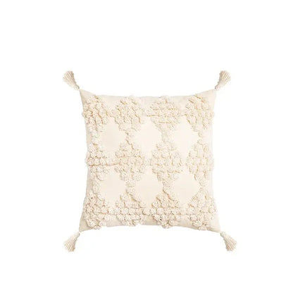 Cream-colored square pillow cover with textured raised floral embroidery and tassels decorbites boho tufted beige design