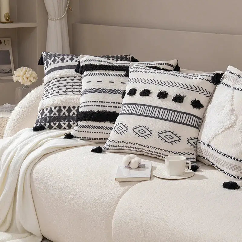 Boho tufted fringed black and white geometric-patterned throw pillows with tassel accents for living room decorbites boho tufted decor