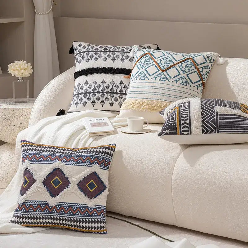 A square throw pillow with a boho tufted fringed textured woven design in navy blue burgundy and cream tones decorbites boho tufted