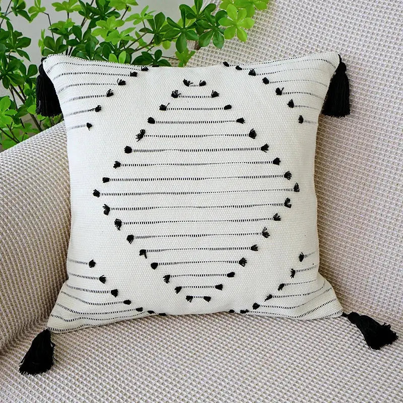 White throw pillow with black embroidered lines and tassels boho tufted fringed black living room decorbites decor
