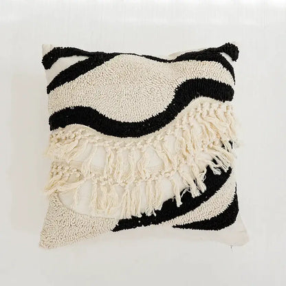 Textured black and cream boho tufted pillow cover with wavy layered patterns and fringe detailing by decorbites