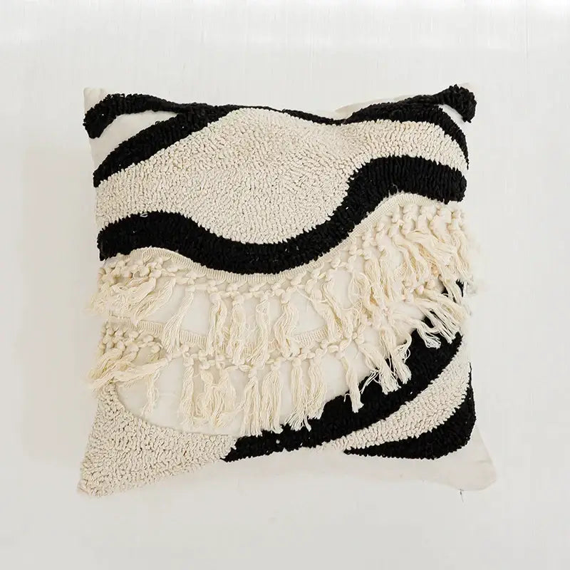Textured black and cream boho tufted pillow cover with wavy layered patterns and fringe detailing by decorbites