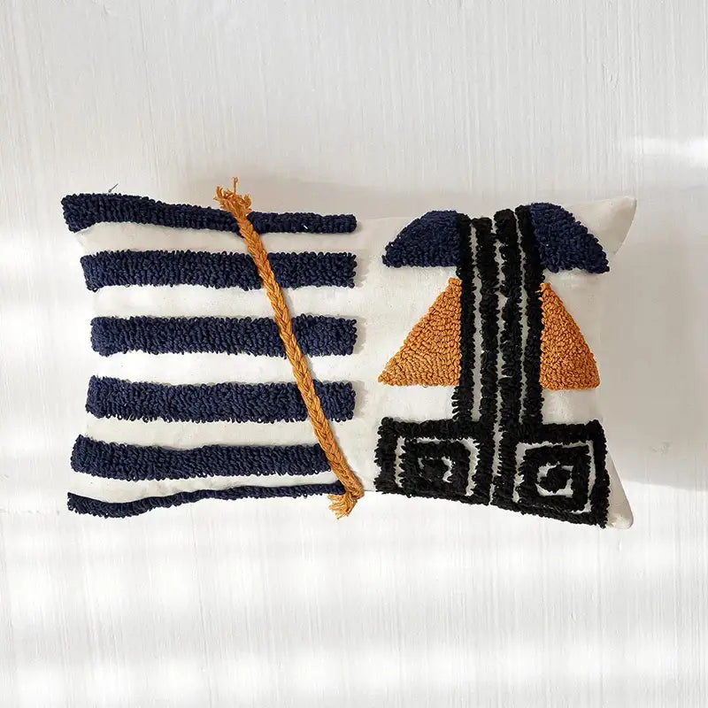 Rectangular white pillow cover with navy blue and mustard tufted stripes and geometric boho tufted pillow design