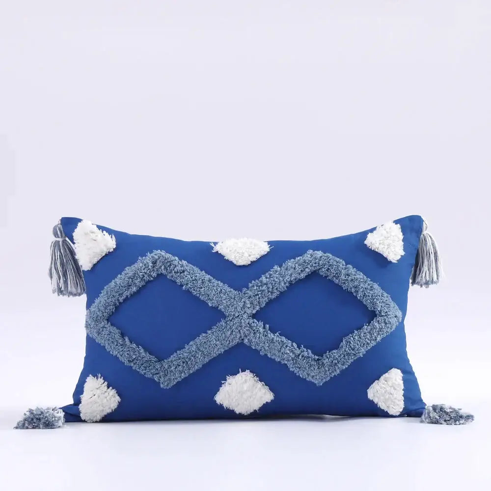 Vibrant blue boho tufted tassel cushion cover with light gray geometric pattern and white pom-poms for living room decor