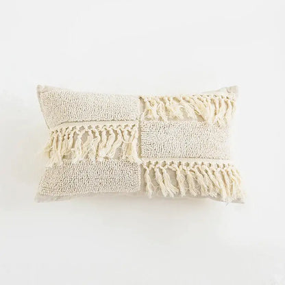 Beige rectangular cushion cover with textured patchwork, boho tufted tassel, and woven fringe decorbites boho tufted design