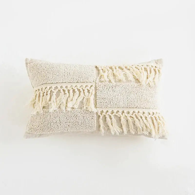 Beige rectangular cushion cover with textured patchwork, boho tufted tassel, and woven fringe decorbites boho tufted design