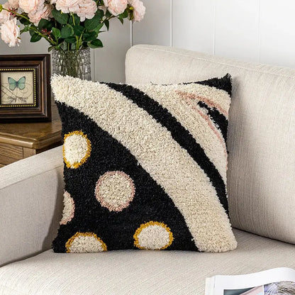 Black and cream textured fluffy tufted pillow cover with gold outlined bold diagonal stripes and circular patterns decorbites black abstract eye