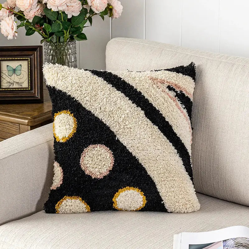 Black and cream textured fluffy tufted pillow cover with gold outlined bold diagonal stripes and circular patterns decorbites black abstract eye