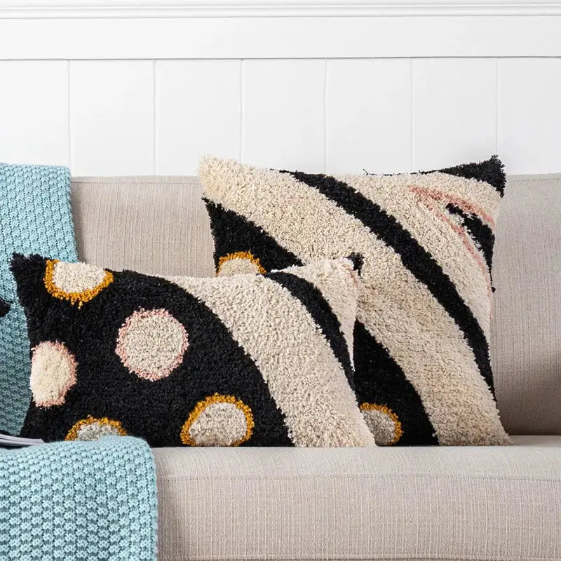 Boho white and black abstract eye pillow cover with black and cream textured patterns in beige pink and gold accents decorbites black abstract