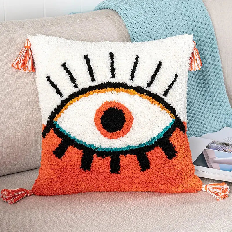 Boho white and black pillow cover with bold embroidered black abstract eye design and matching tassels for living room decorbites black abstract