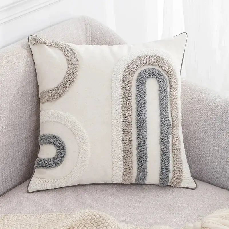 Cream-colored boho loop pillowcase with textured gray and beige tufted rainbow design for living room decor