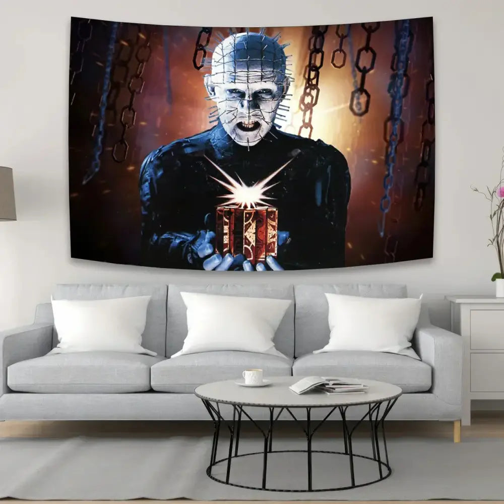 Black and orange horror movie wall tapestry featuring pinhead holding a glowing box above a gray sofa decorbites jack-o-lantern wall