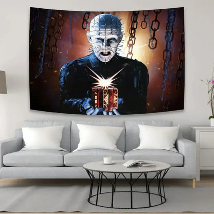 Black and orange horror movie wall tapestry featuring pinhead holding a glowing box above a gray sofa decorbites jack-o-lantern wall