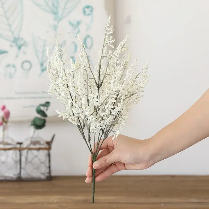 Boho wicker basket with delicate white decorbites forever dancing grass flowers and slender green stems arrangement