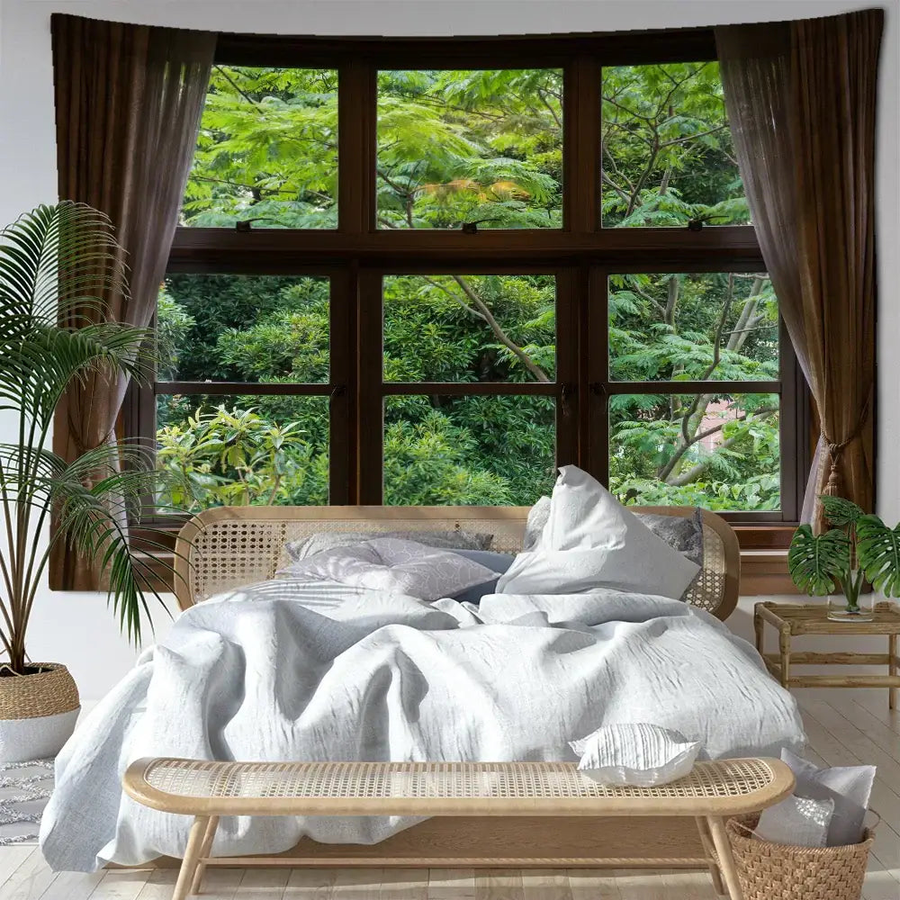 A cozy bed with a woven rattan frame and soft white linen bedding in a boho window jungle scenery wall tapestry bedroom decorbites jungle scenery