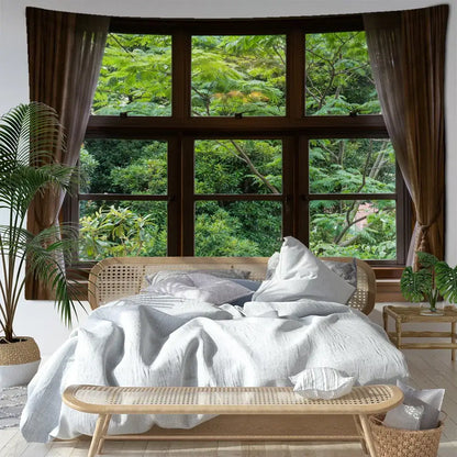 A cozy bed with a woven rattan frame and soft white linen bedding in a boho window jungle scenery wall tapestry bedroom decorbites jungle scenery