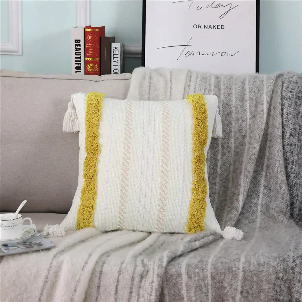 White knit pillow case with mustard yellow tassel trim and textured vertical stripes decorbites boho woven tassel design