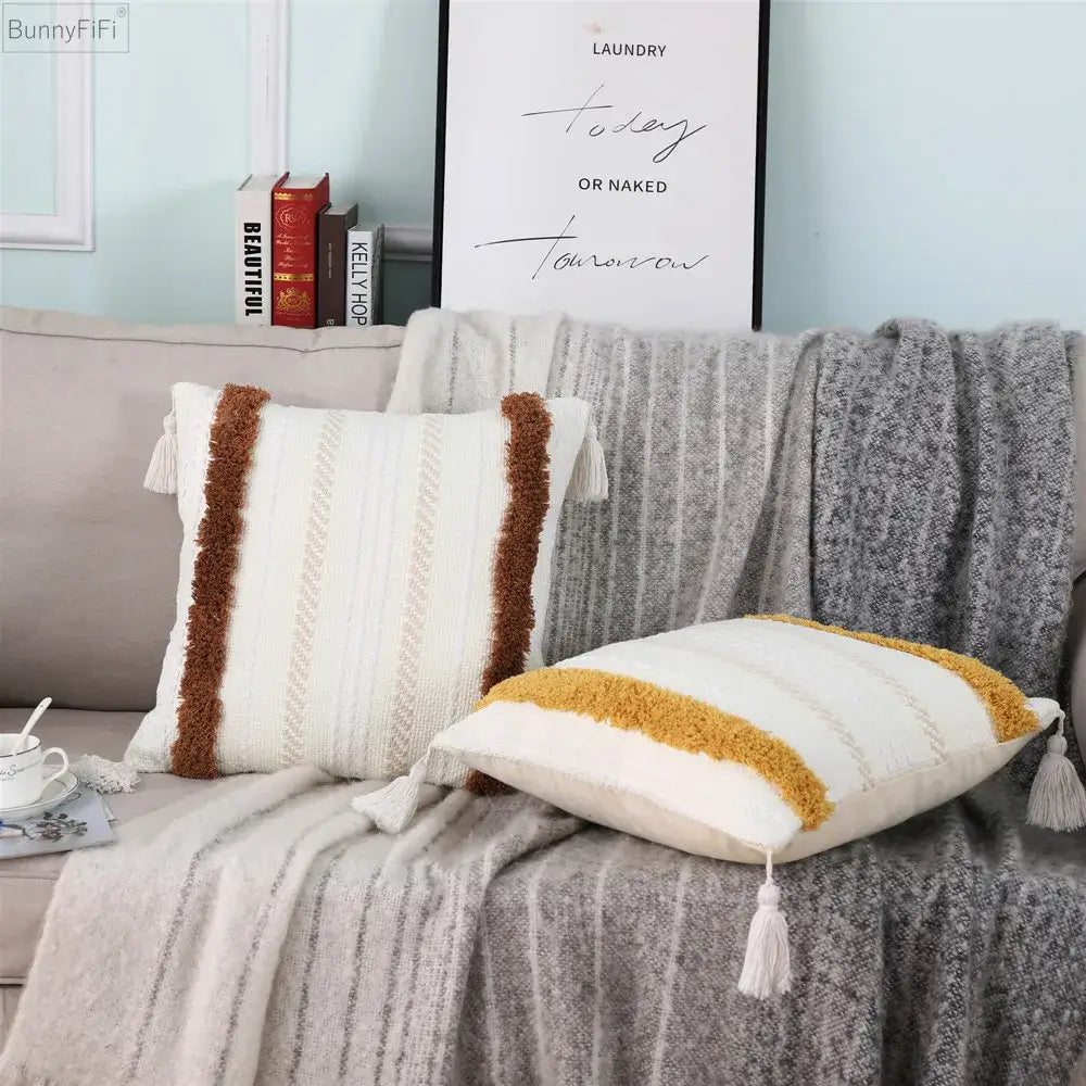 Cream-colored pillow case with brown and mustard-yellow textured tassels in decorbites boho woven tassel design