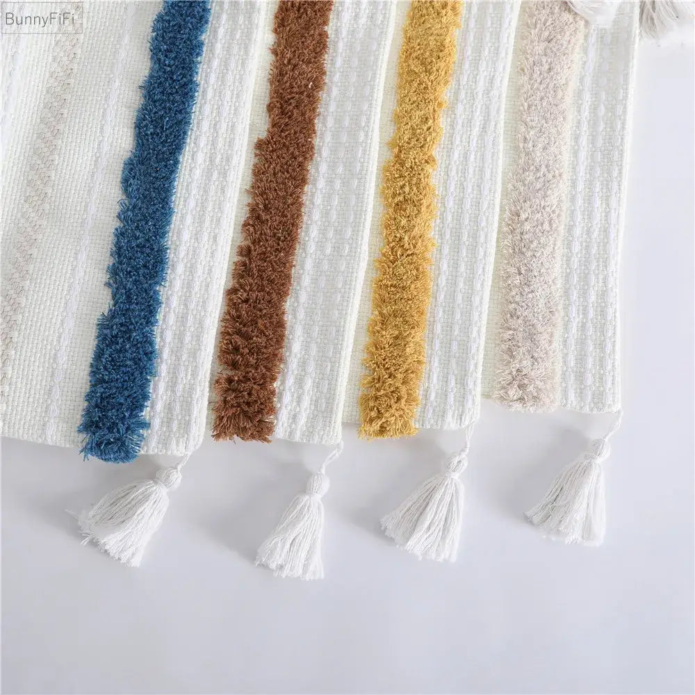 Cozy boho woven tassel pillow case featuring a textured throw with plush blue, brown, mustard yellow, and beige stripes