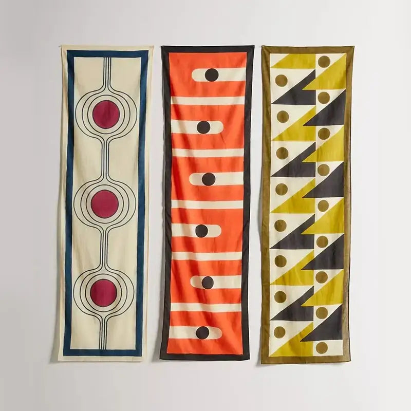 Boho yellow and black celestial geometry tapestry featuring three vibrant silk fabric panels with bold geometric patterns