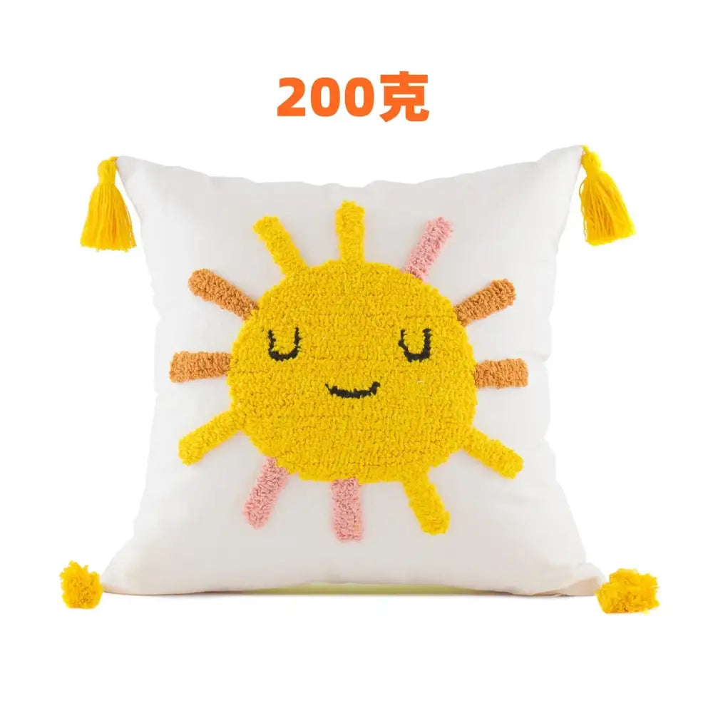 White cushion cover featuring cheerful yellow sun with orange pink rays and bright yellow tassels decorbites boho yellow