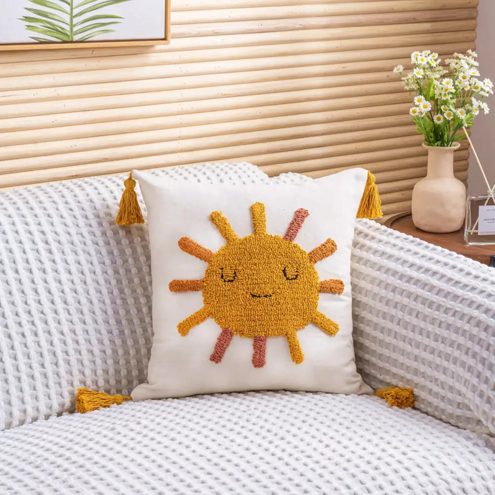 White cushion cover with cheerful textured yellow sun face embroidery and mustard-yellow tassels decorbites boho yellow rainbow