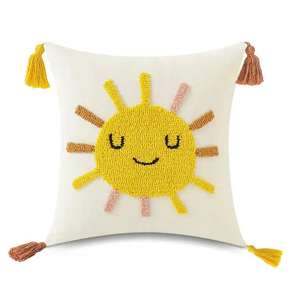 Cream-colored pillow cover with cheerful yellow sun in textured yarn and tassels for decorbites boho yellow rainbow style decor