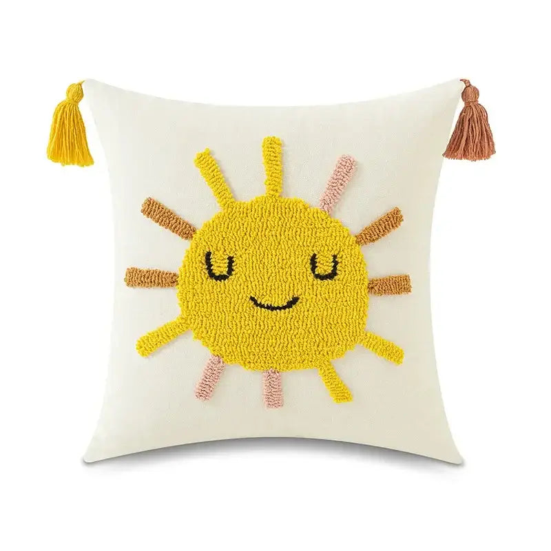 Cream-colored pillow cover featuring a cheerful yellow sun in textured yarn with tassels for decorbites boho yellow decor