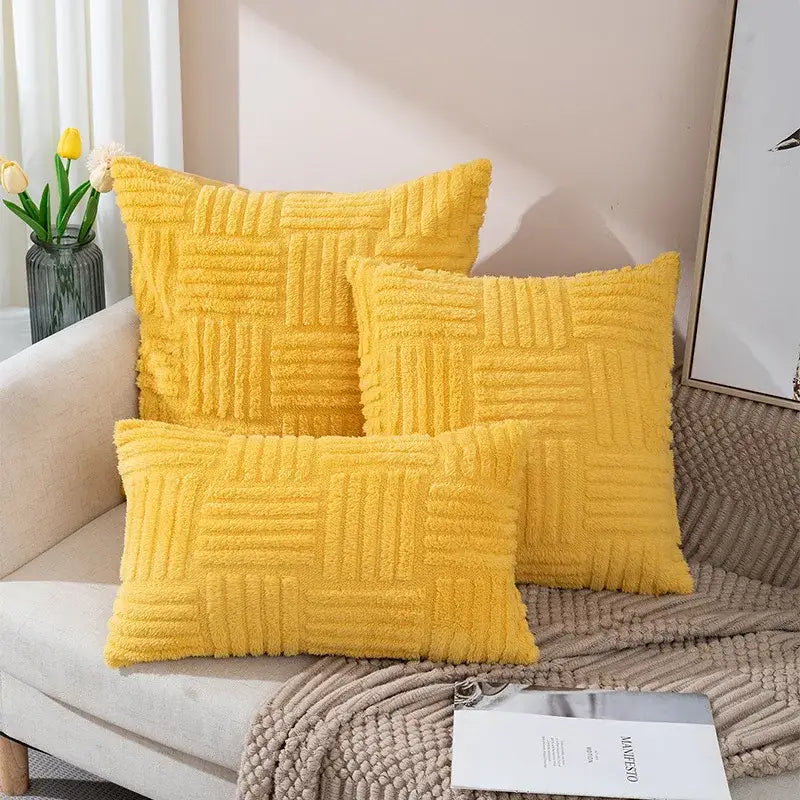 Three vibrant yellow boho textured plush throw pillow covers arranged on a cozy sofa for living room decor