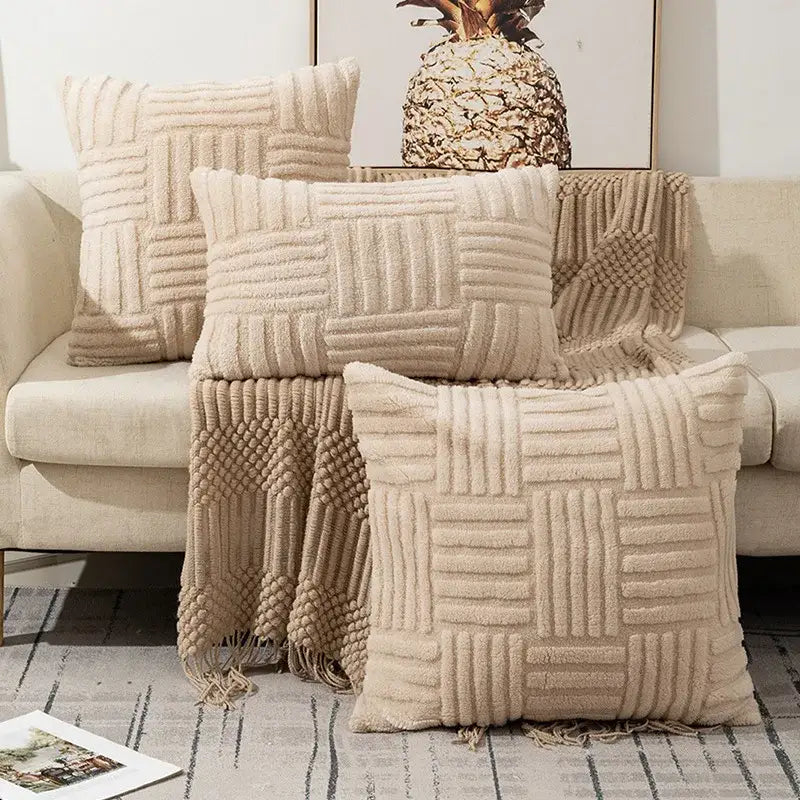 Beige plush throw pillow covers with woven geometric patterns and fringed edges for boho living room decor