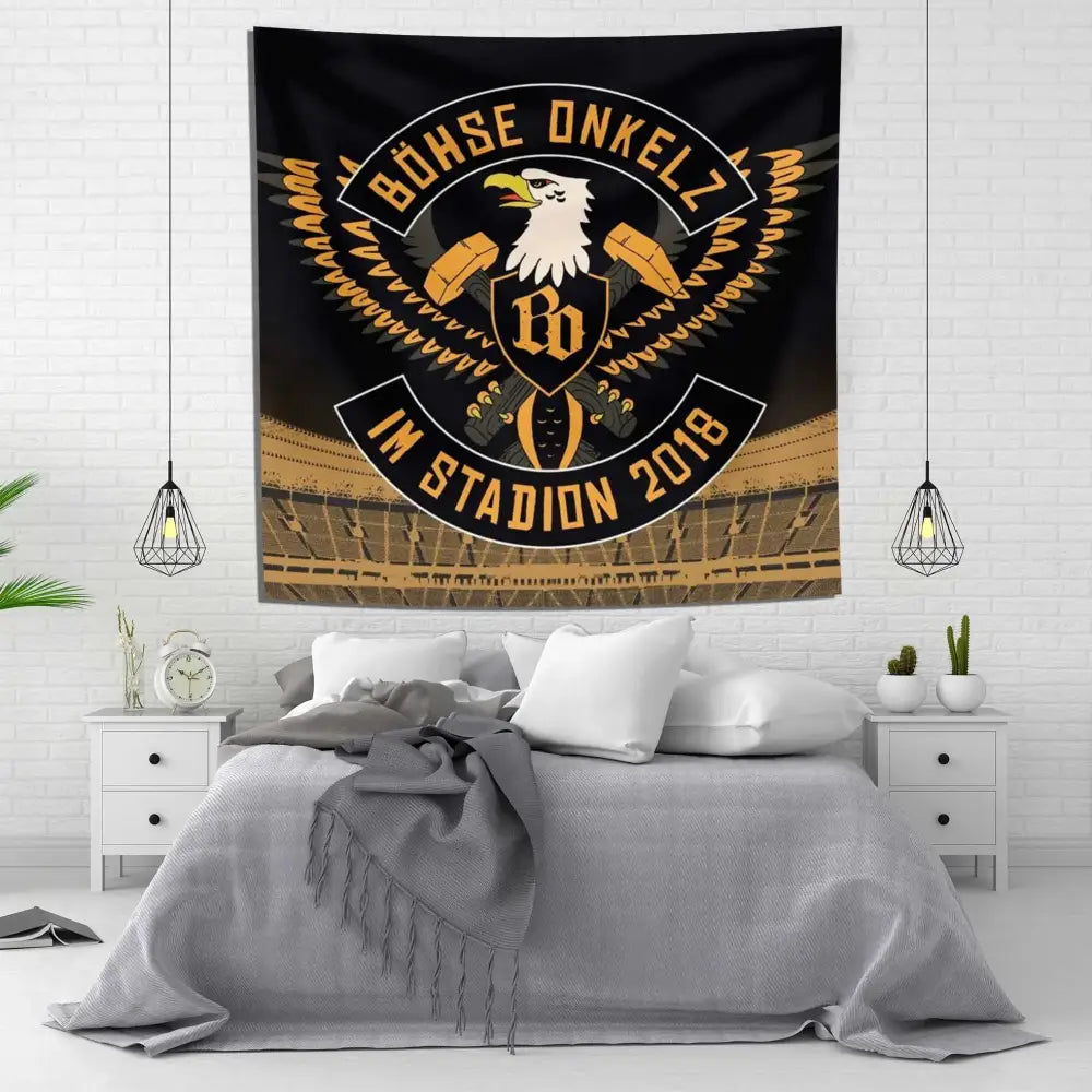 Black and gold tapestry flag with bohse onkelzs stylized eagle emblem and german rock text in a stadium setting