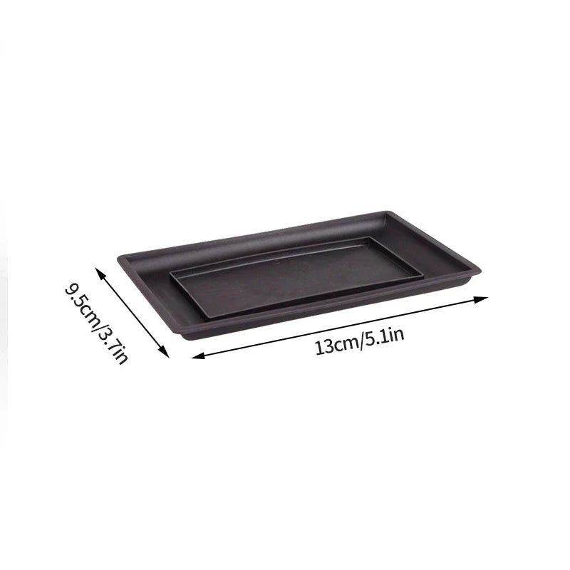 Black rectangular plant pot tray with nested compartment made of smooth matte plastic for outdoor garden use