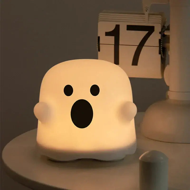 A soft glowing white boo ghost silicone lamp with black eyes and open mouth for bedroom decorbites boo ghost night light