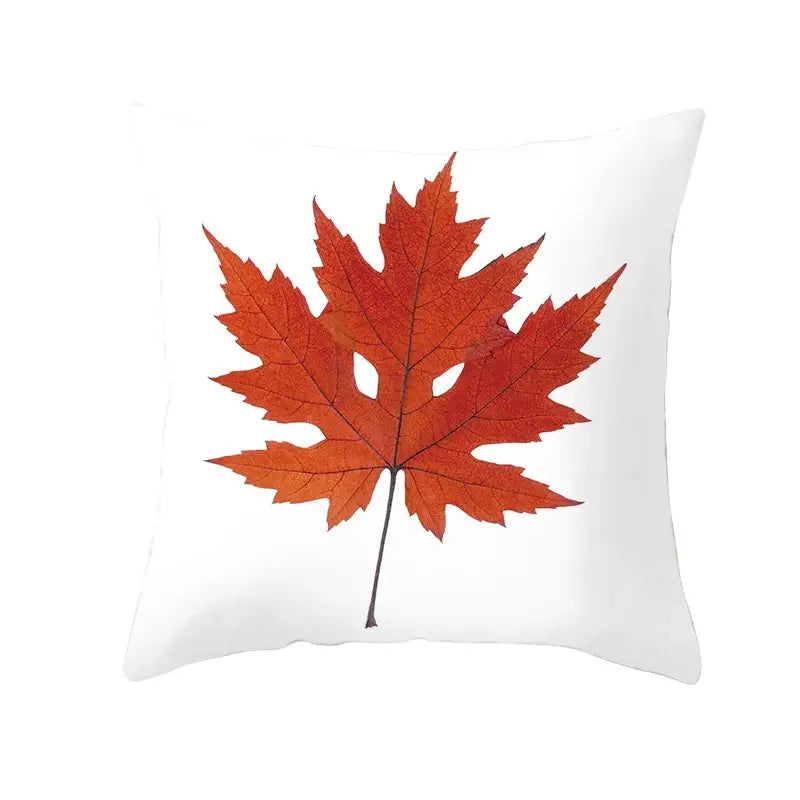 White throw pillow with vibrant orange autumn maple leaf print for living room decor featuring autumn maple leaves